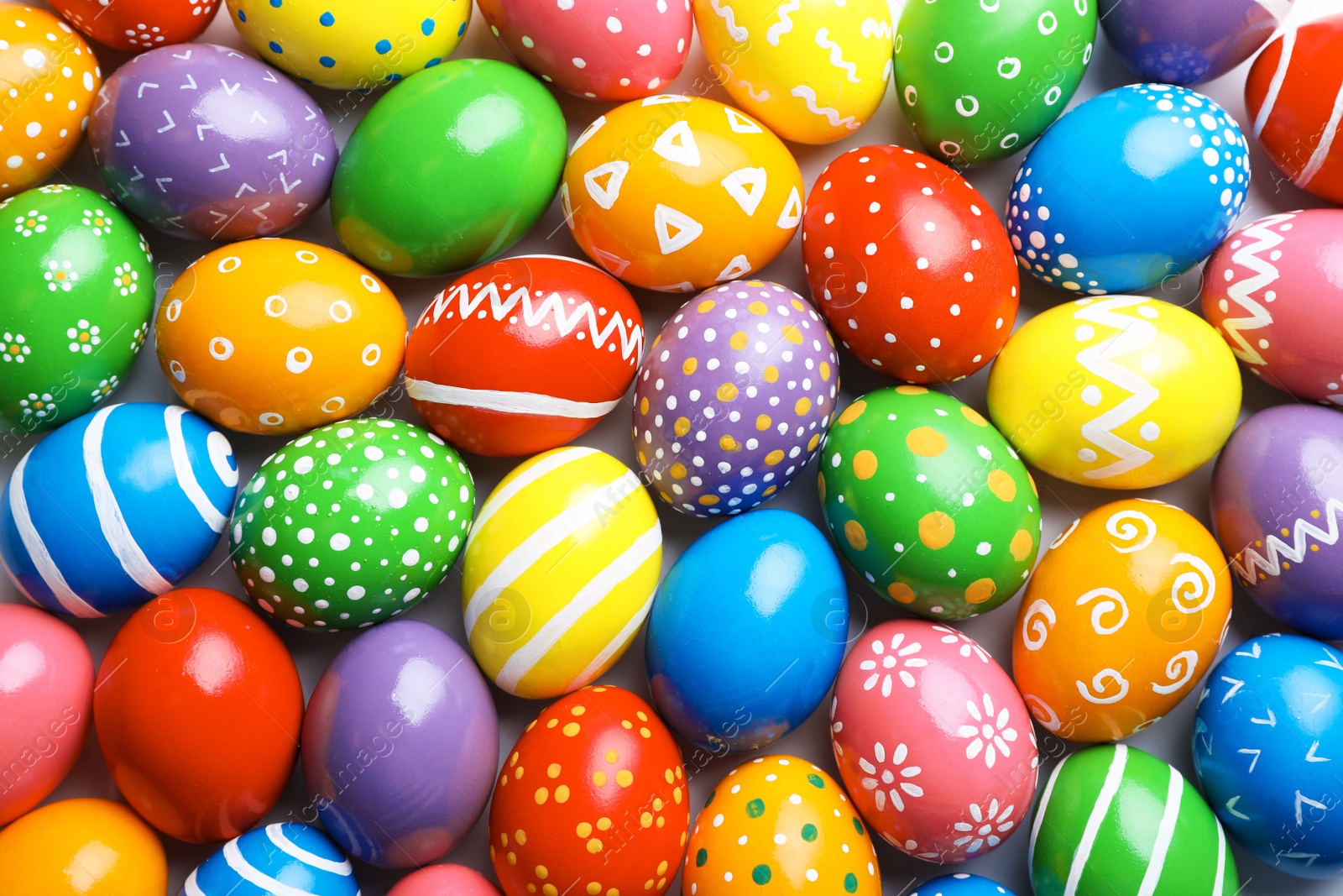 Photo of Many decorated Easter eggs as background, top view. Festive tradition