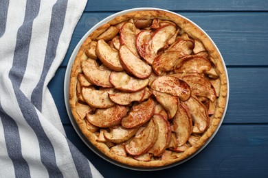 Photo of Delicious apple pie on blue wooden table, top view