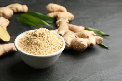 Photo of Dry and fresh ginger on black slate table, closeup