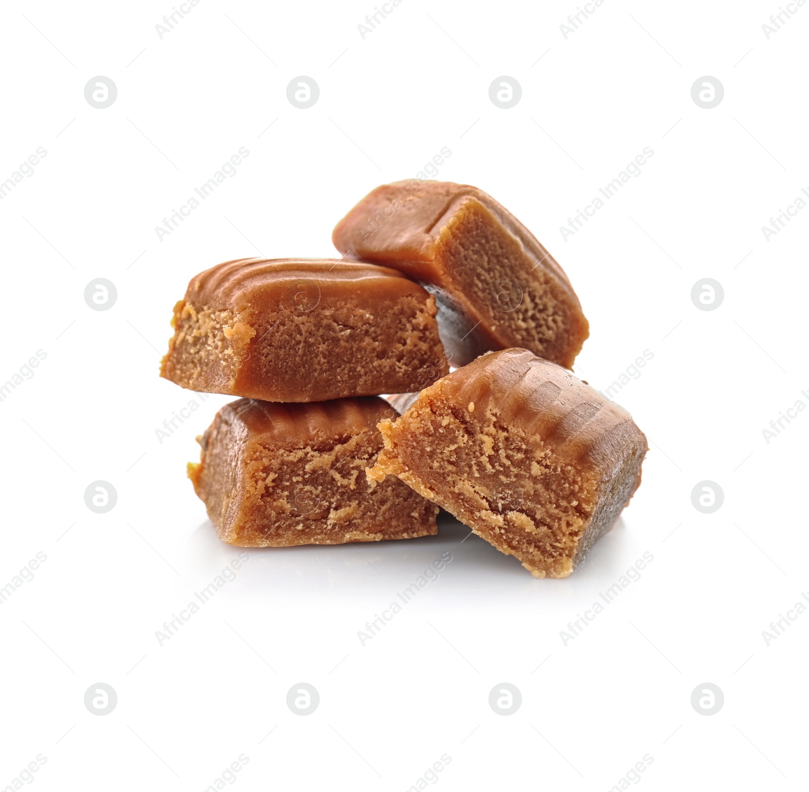 Photo of Delicious caramel candies on white background