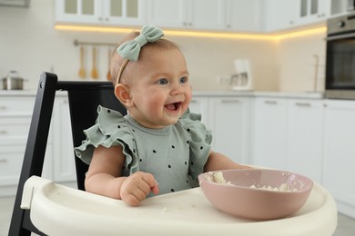 Cute little girl eating healthy food at home