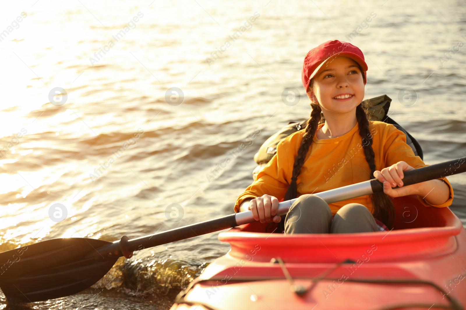 Photo of Happy girl kayaking on river. Summer camp activity