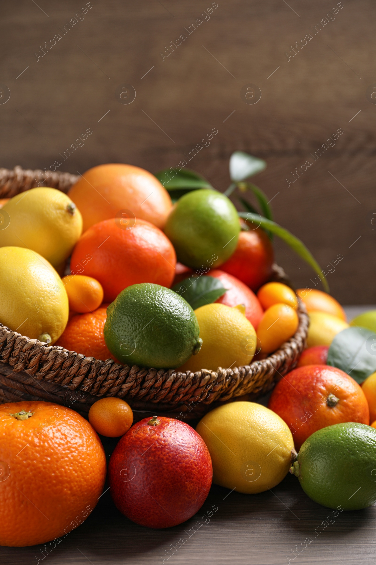 Photo of Different ripe citrus fruits on wooden table