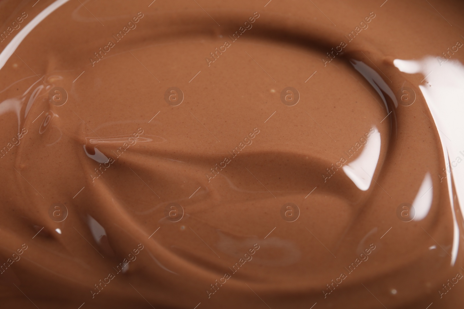 Photo of Tasty milk chocolate paste as background, closeup view