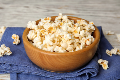 Tasty pop corn on white wooden table, closeup