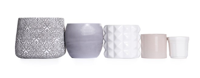 Photo of Different stylish ceramic flowerpots on white background