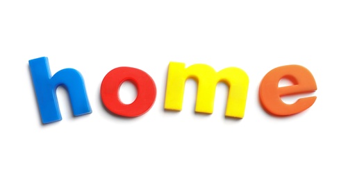 Photo of Word HOME of magnetic letters on white background, top view