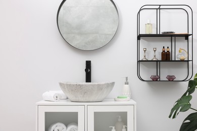 Photo of Different bath accessories, personal care products and bathroom vanity indoors