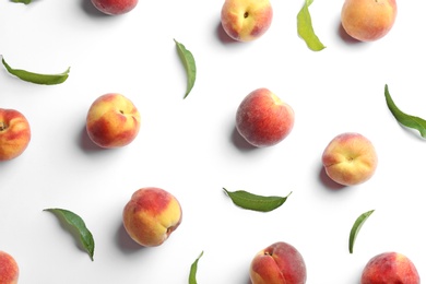 Composition with fresh peaches on white background, top view