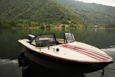 Photo of Beautiful boat on river and mountains in park