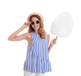 Happy young woman with cotton candy on white background