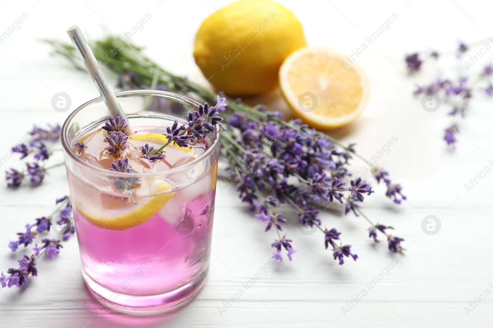 Photo of Fresh delicious lemonade with lavender on white wooden table. Space for text