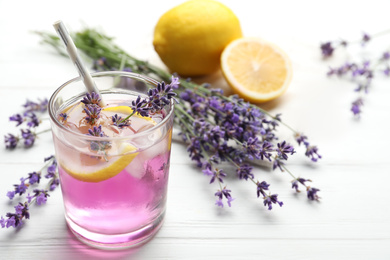 Fresh delicious lemonade with lavender on white wooden table. Space for text