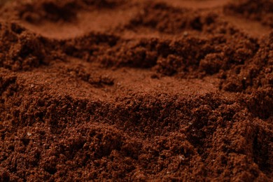 Photo of Dry ground coffee as background, closeup view