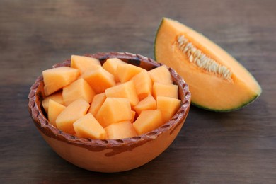 Photo of Cut delicious ripe melon on wooden table, closeup