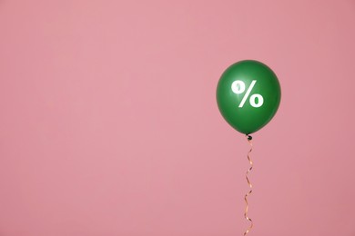 Image of Discount offer. Green balloon with percent sign on pink background, space for text