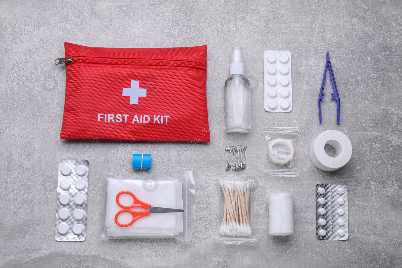 Photo of Flat lay composition with first aid kit on light gray background