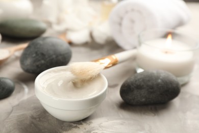 Photo of Cosmetic product for spa body wraps on light grey stone background