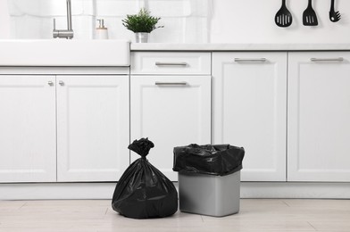 Photo of Plastic garbage bag and trash can in kitchen