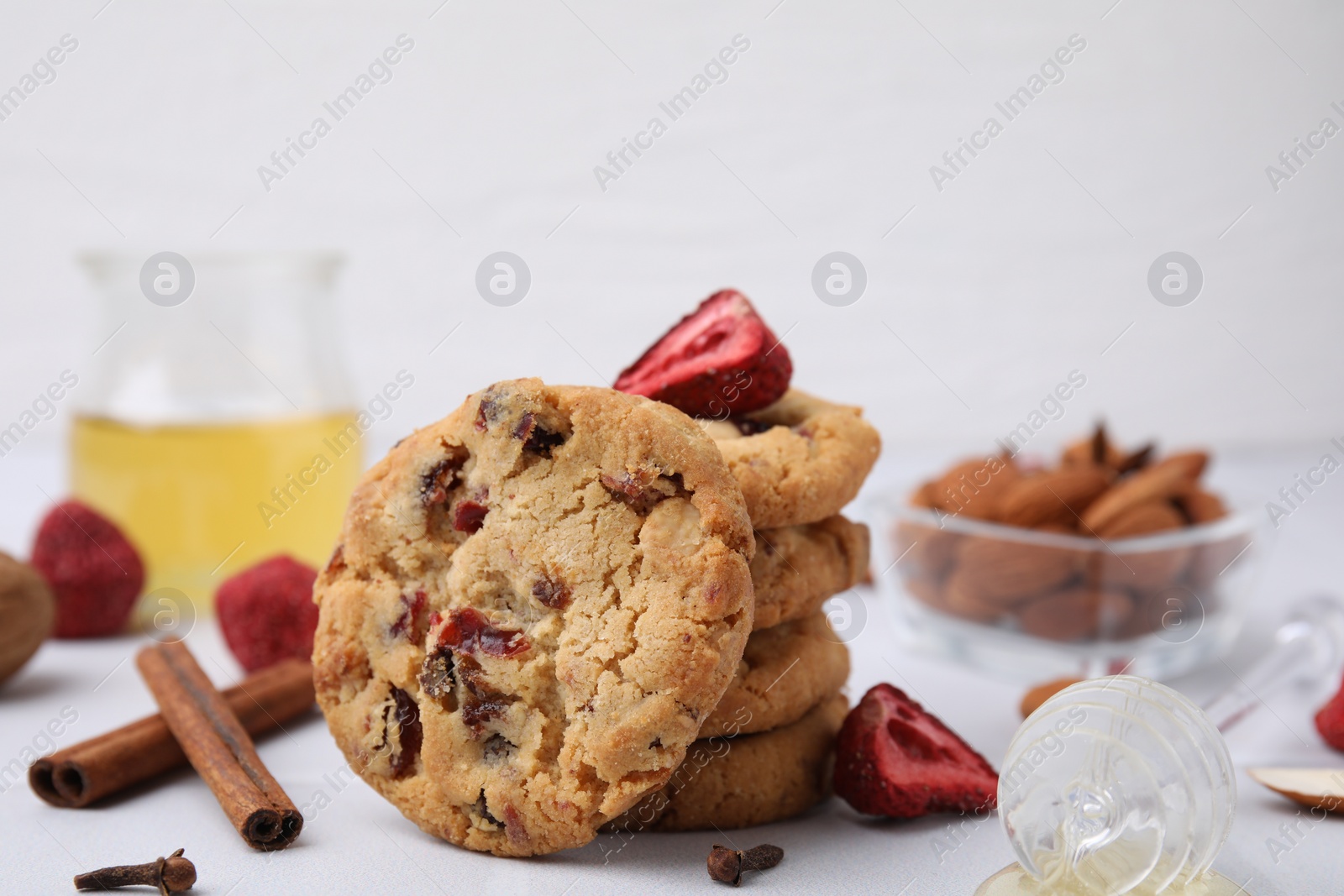 Cookies with freeze dried fruits, cinnamon, honey and nuts on white table, closeup Photo of Cookies with freeze dried fruits, cinnamon, honey and nuts on white table, closeup