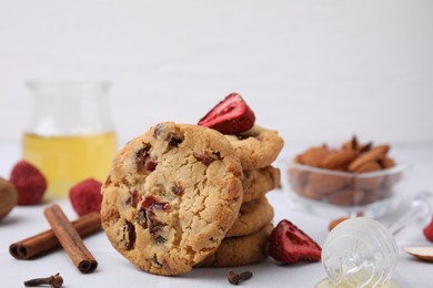 Photo of Cookies with freeze dried fruits, cinnamon, honey and nuts on white table, closeup