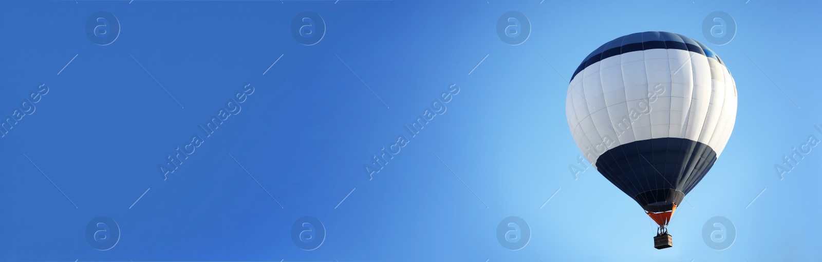 Image of Hot air balloon in blue sky, space for text. Banner design 