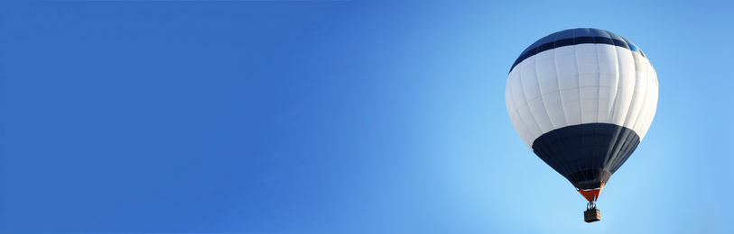Image of Hot air balloon in blue sky, space for text. Banner design 