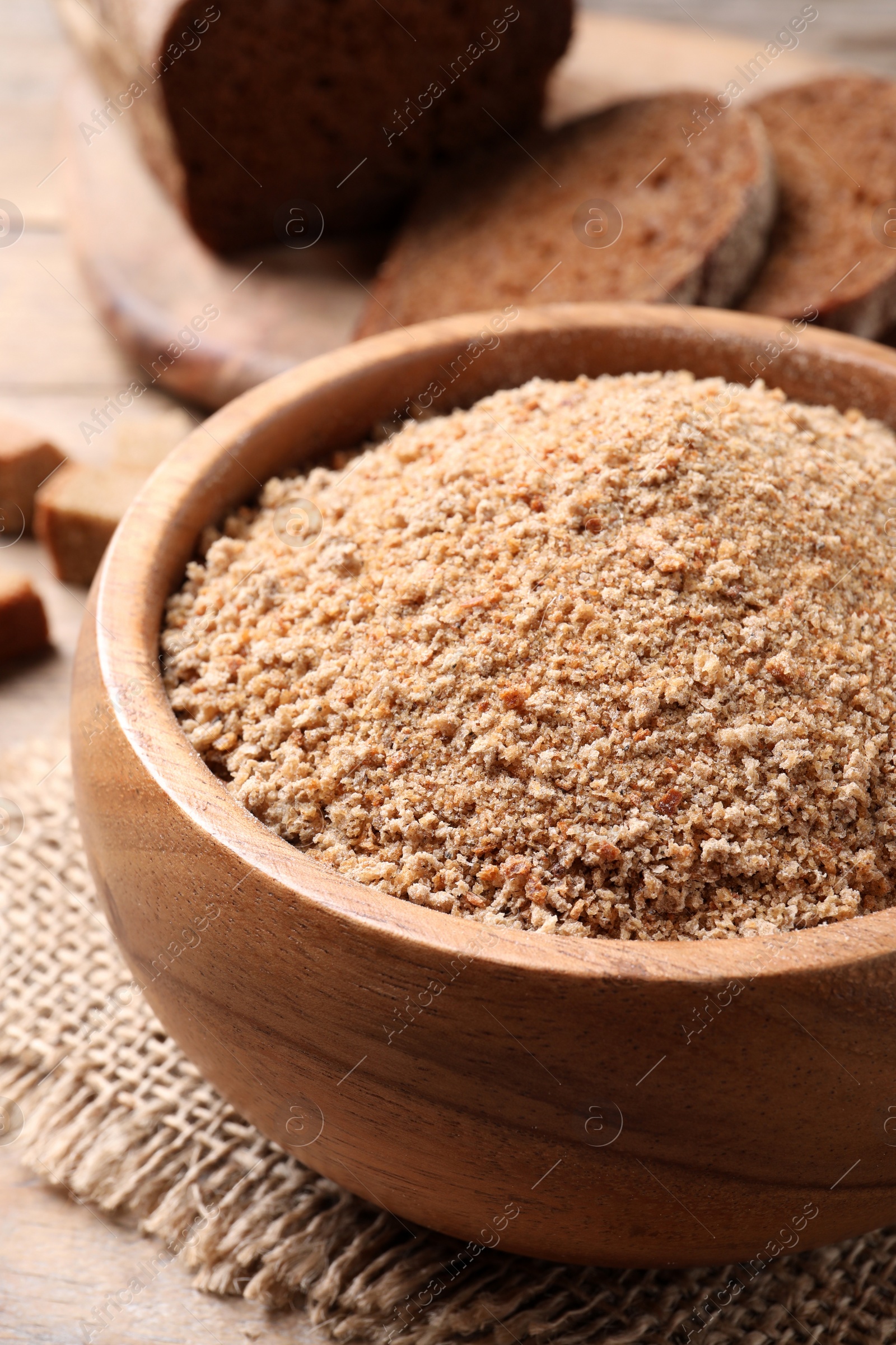 Photo of Fresh breadcrumbs in bowl on table, closeup