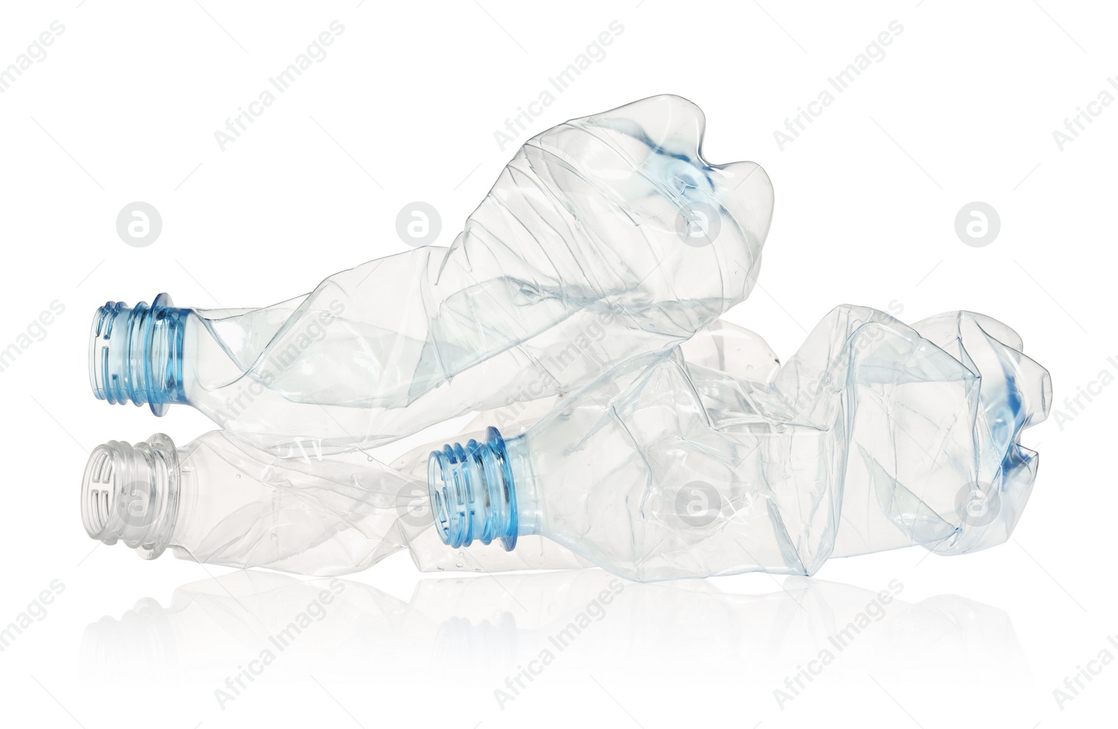 Photo of Crumpled disposable plastic bottles isolated on white