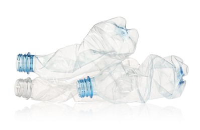 Photo of Crumpled disposable plastic bottles isolated on white