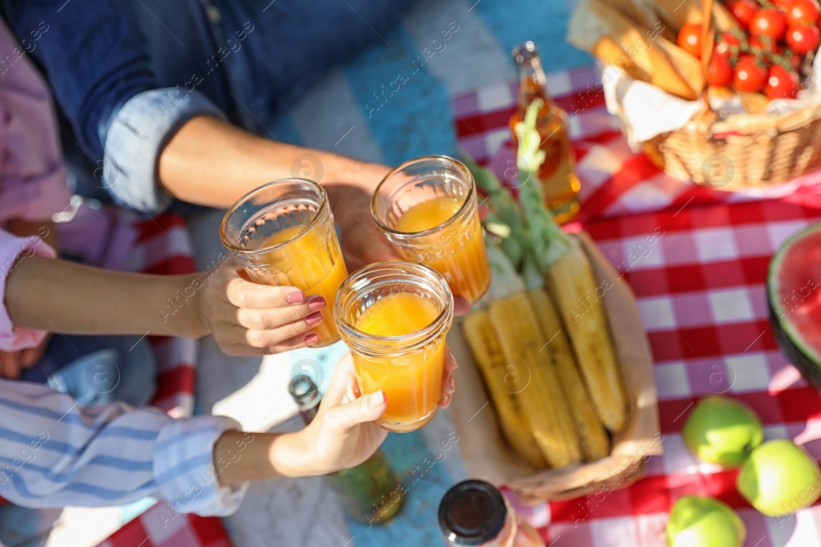 Photo of Young people enjoying picnic in park on summer day, closeup