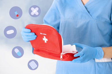 Image of Doctor in medical gloves with first aid kit on blurred background