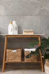 Storage baskets with towels, detergents and houseplant indoors