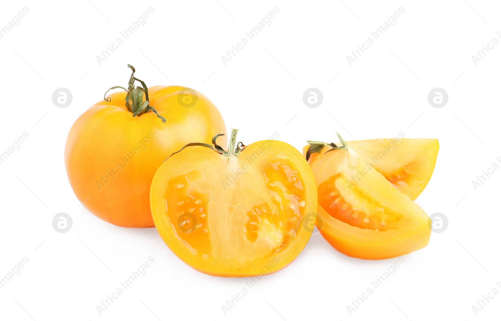 Photo of Cut and whole yellow tomatoes on white background