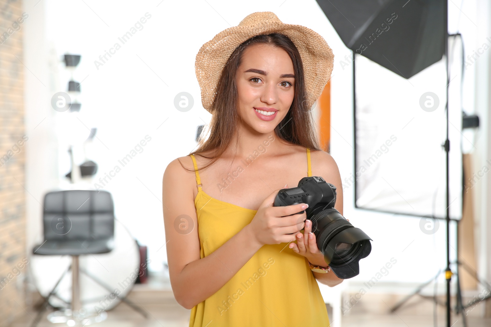 Photo of Professional photographer with camera in photo studio