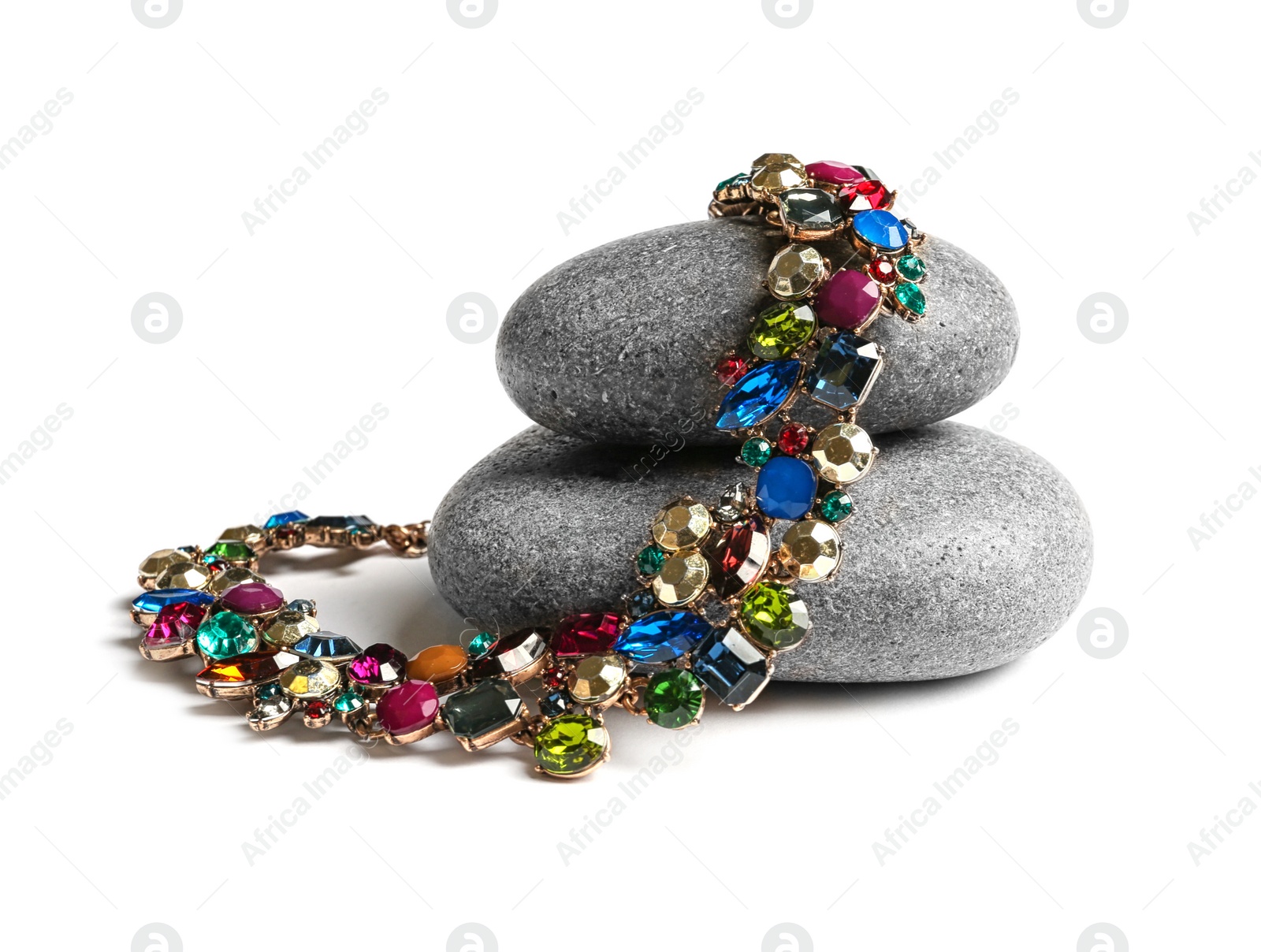 Photo of Stones with elegant necklace on white background. Luxury jewelry