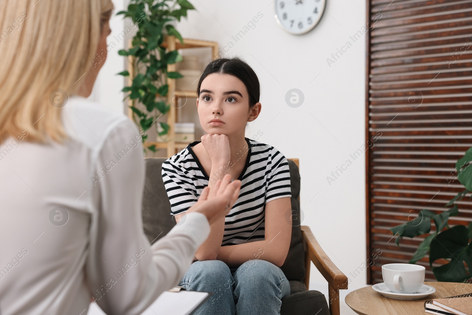 Photo of Psychologist working with teenage girl in office