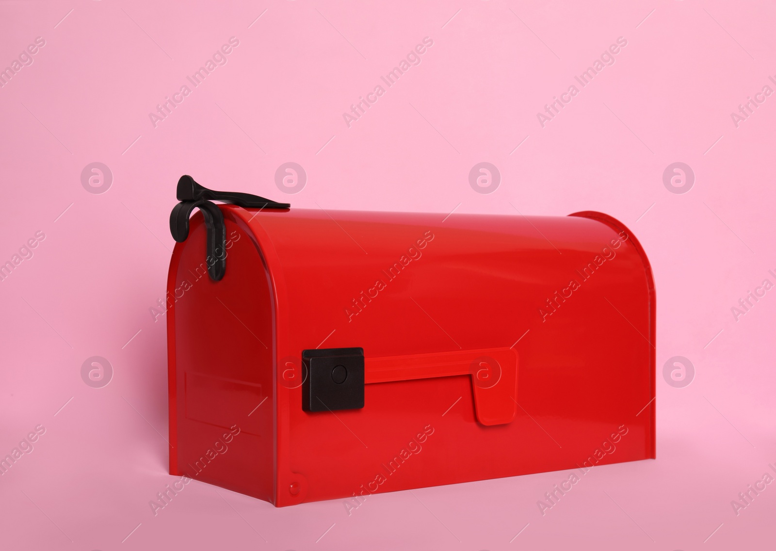 Photo of Closed red letter box on pink background