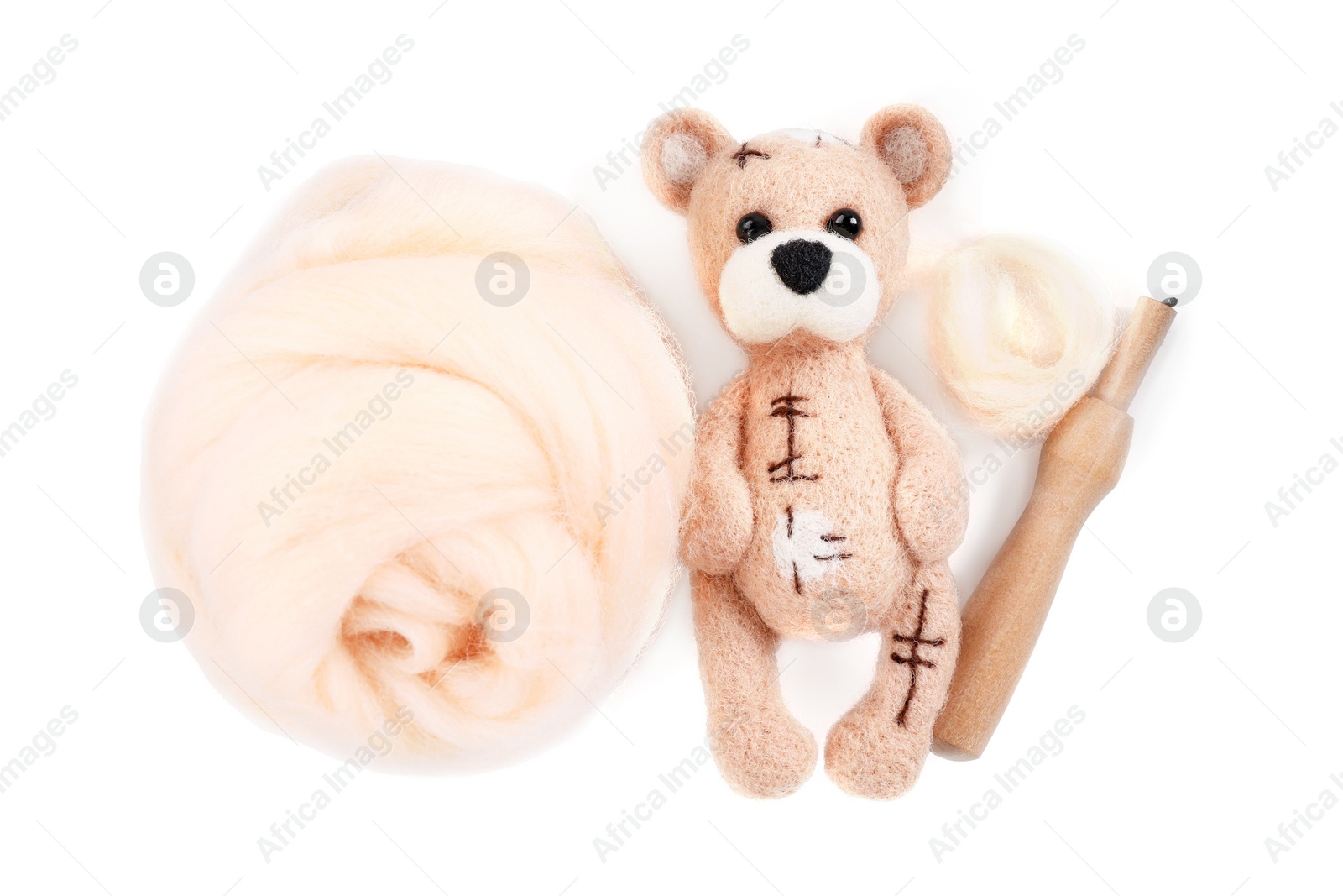 Photo of Needle felted bear, wool and holder isolated on white, top view