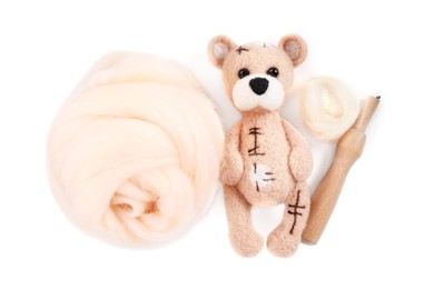 Photo of Needle felted bear, wool and holder isolated on white, top view