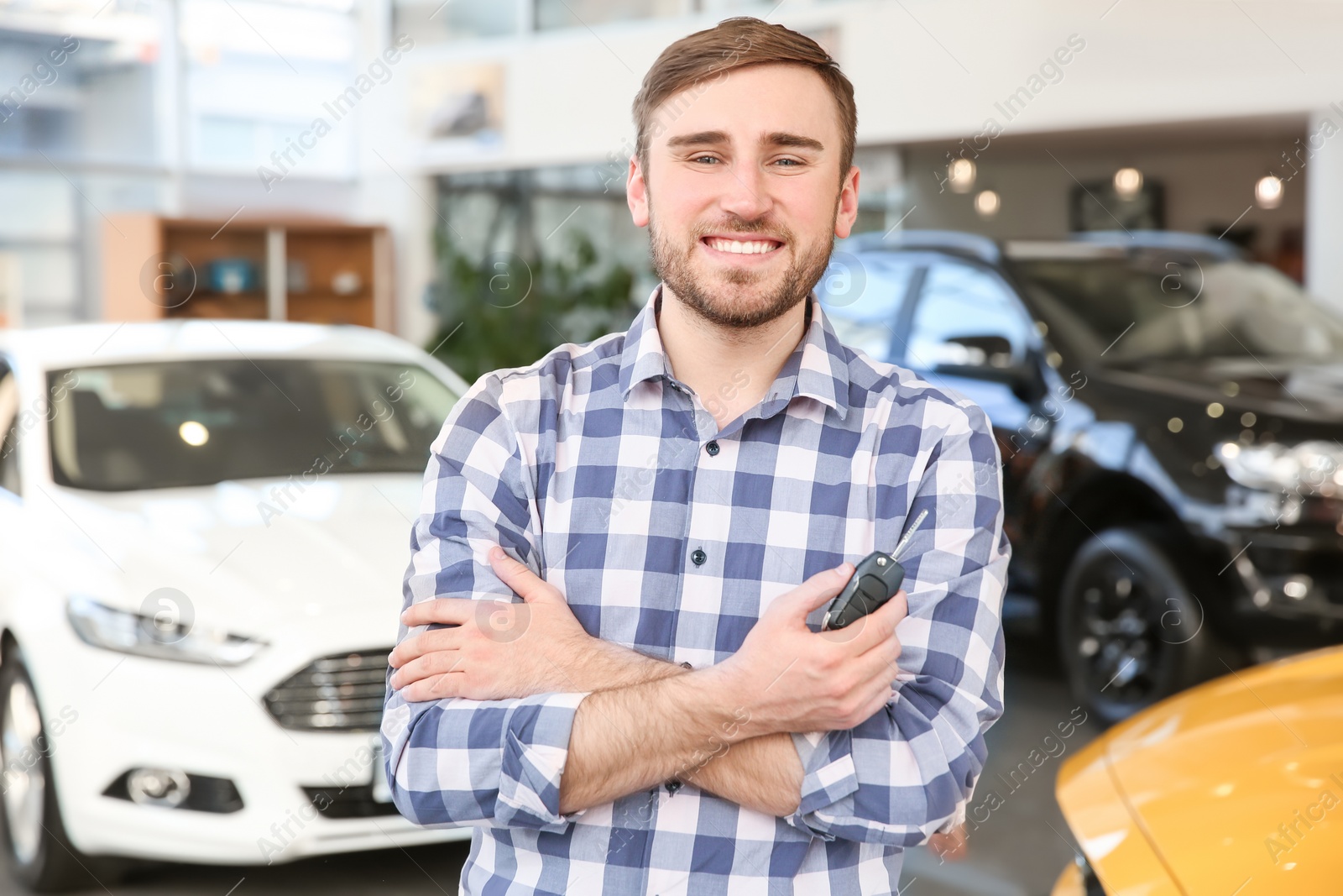 Photo of Young man holding car key in salon