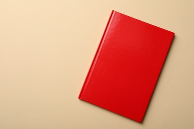 Photo of New red planner on beige background, top view. Space for text