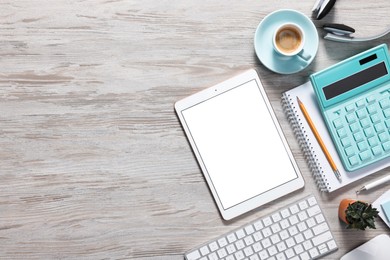 Flat lay composition with modern tablet on white wooden table. Space for text