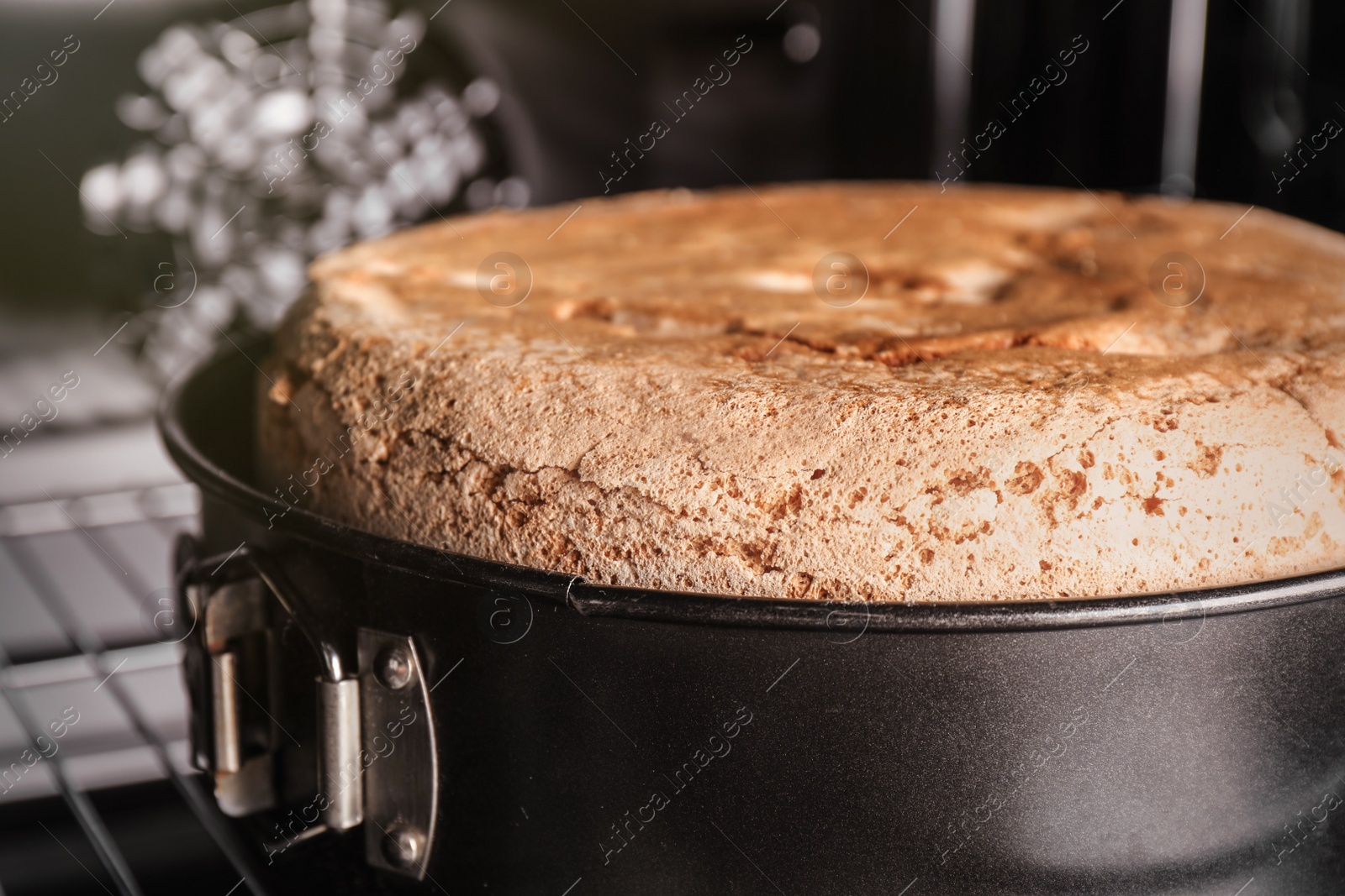 Photo of Delicious fresh homemade cake in oven, closeup