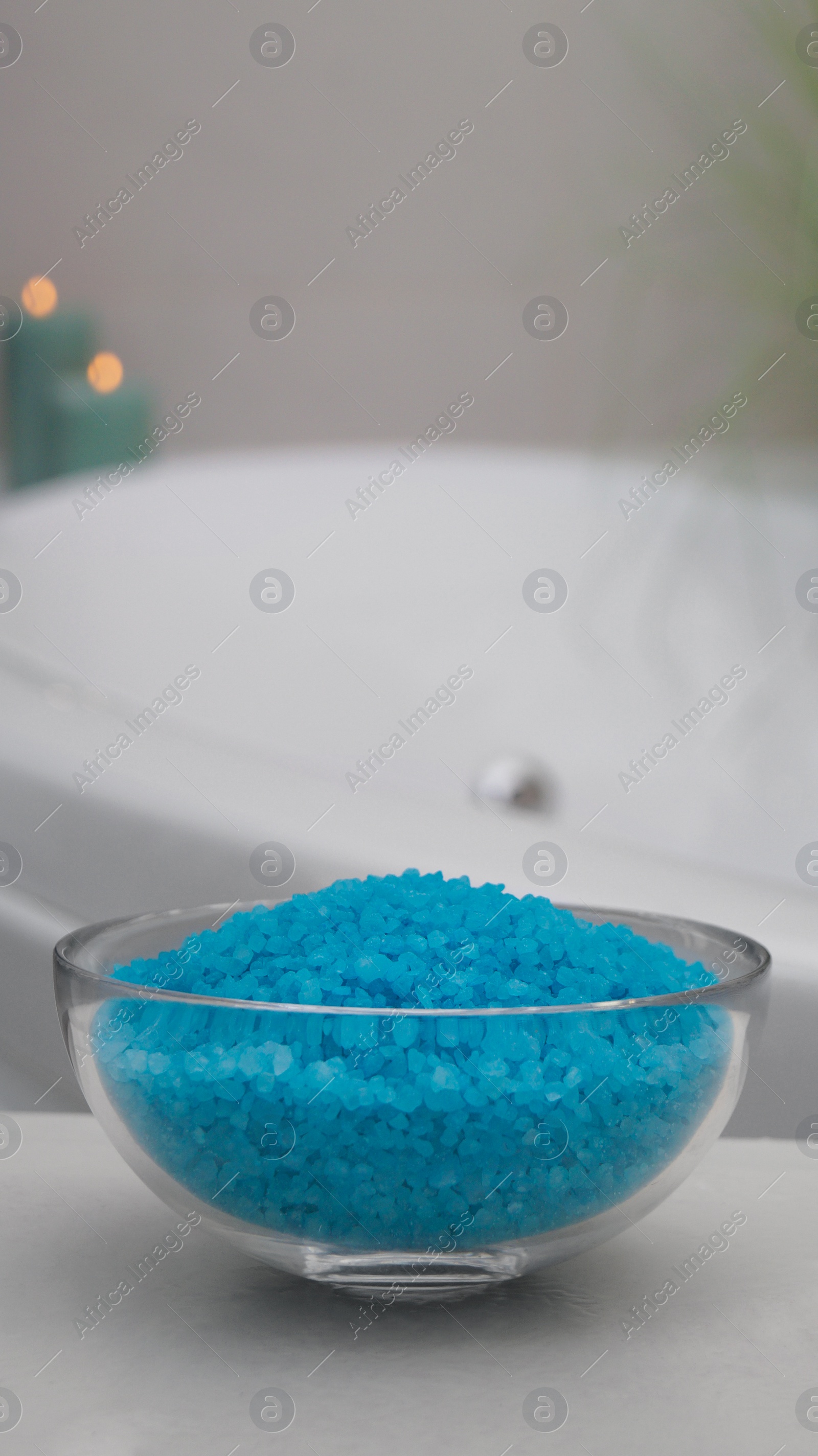 Bowl with bath salt on table in bathroom Photo of Bowl with bath salt on table in bathroom