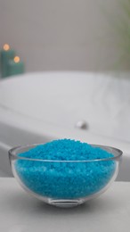 Photo of Bowl with bath salt on table in bathroom