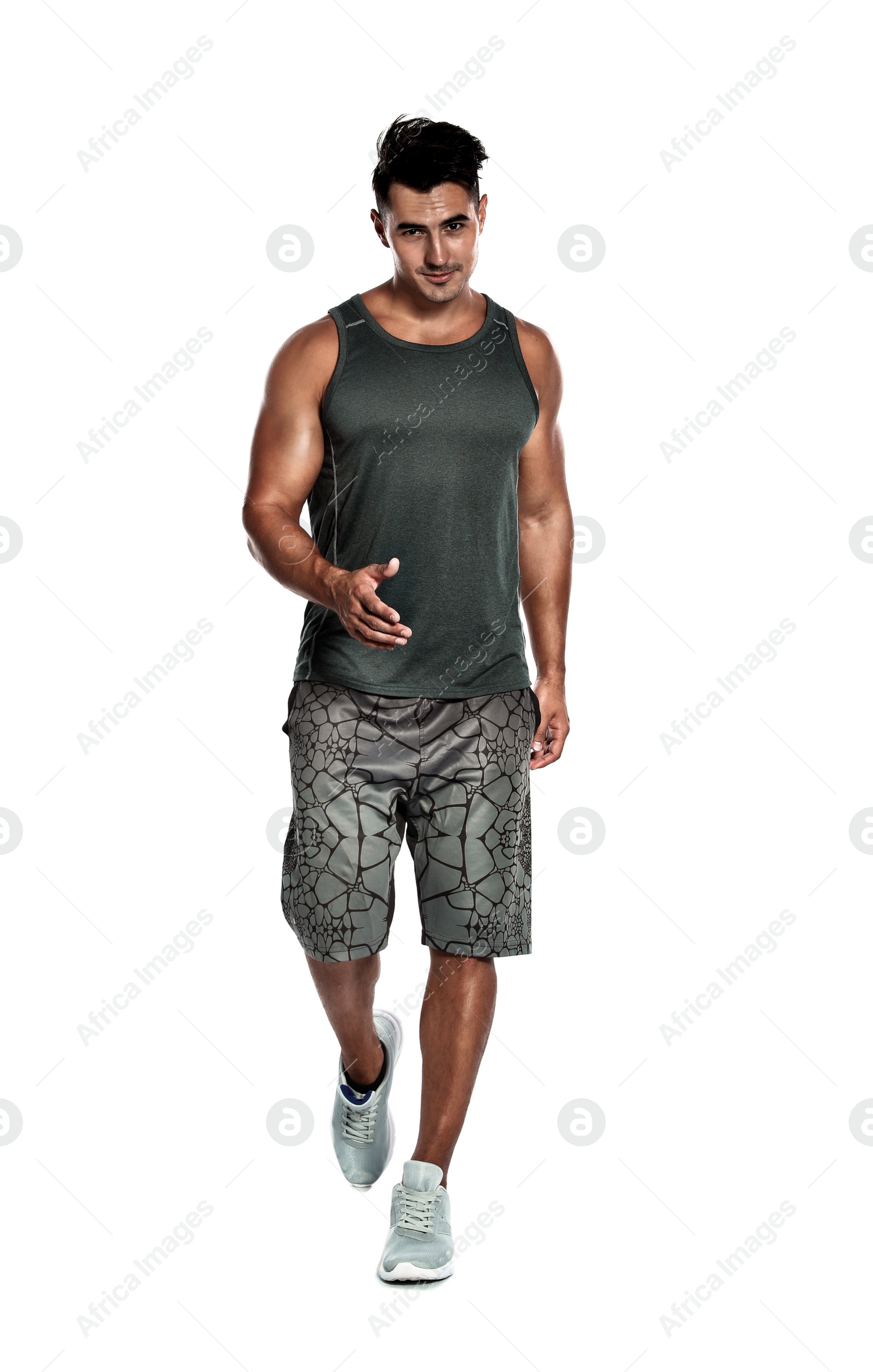 Photo of Handsome young runner posing on white background