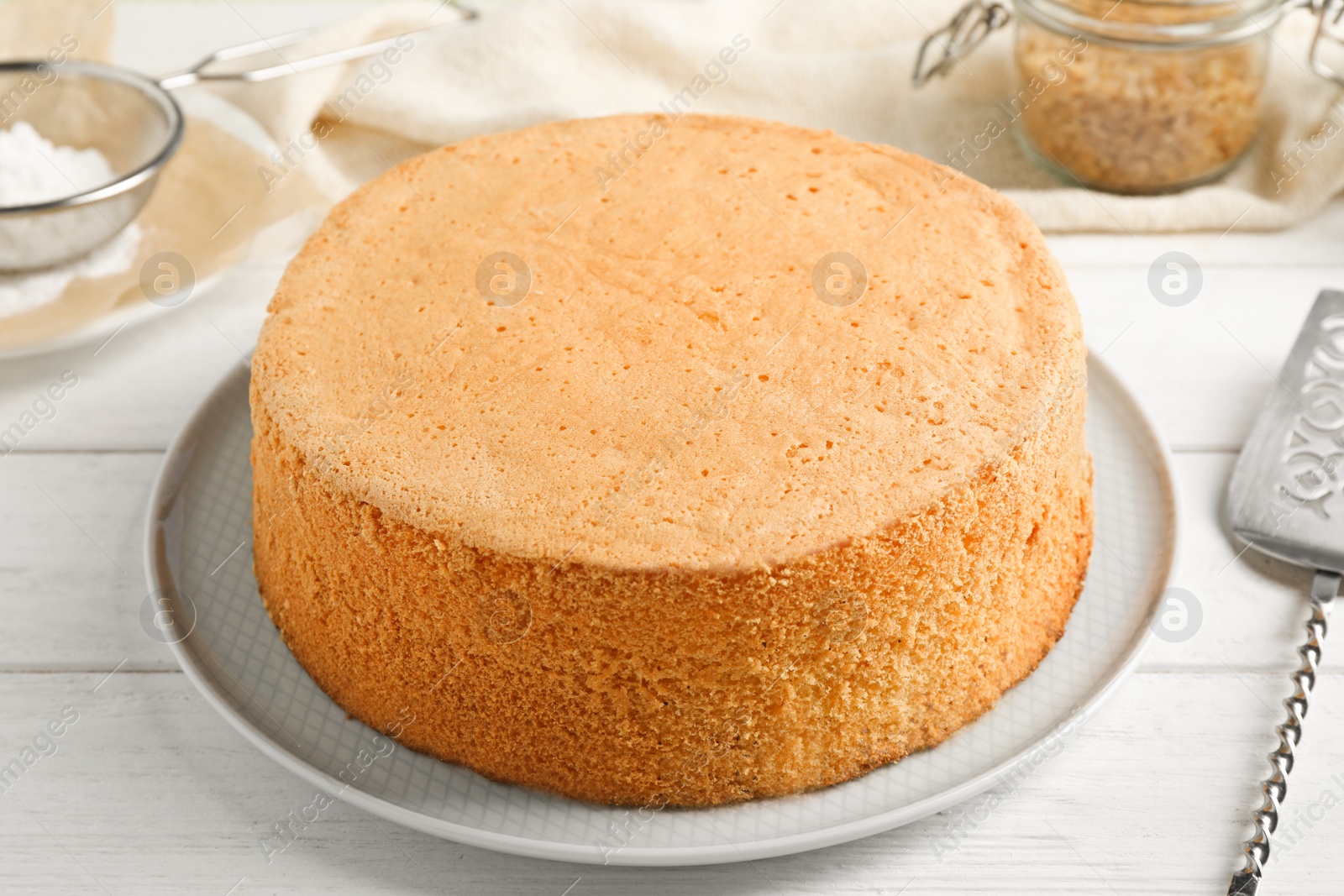 Photo of Delicious fresh homemade cake on white wooden table