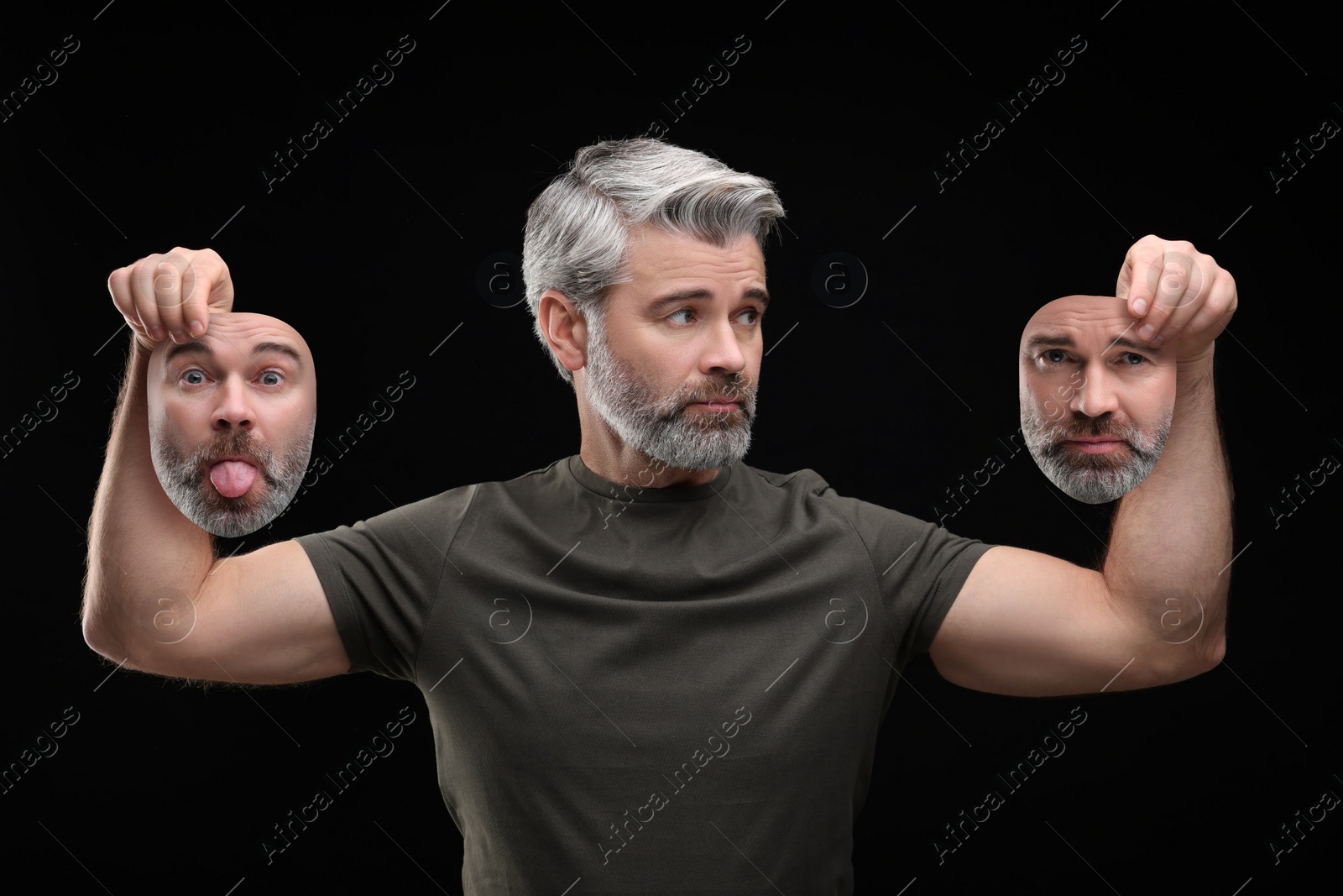 Image of Mature man holding masks with his face showing different emotions on black background. Balanced personality