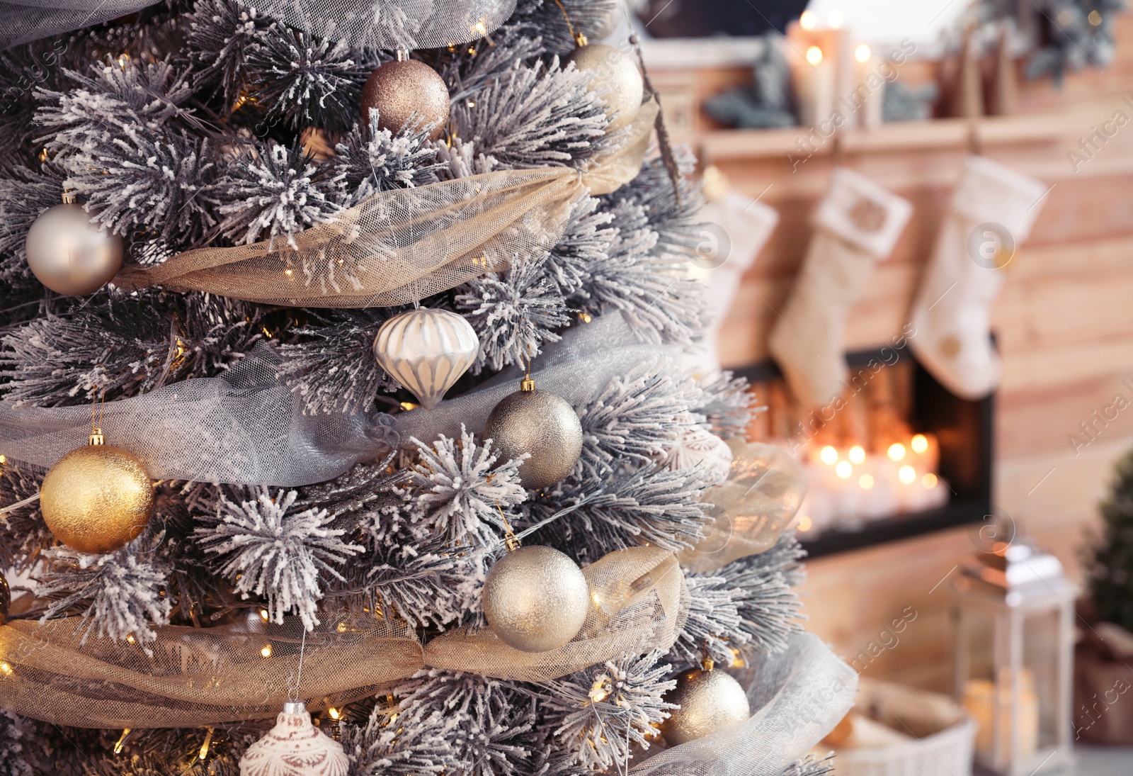 Photo of Closeup view of decorated Christmas tree in room. Festive interior